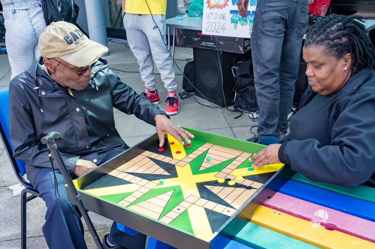 Community members playing board games at Roots & Wings 2024