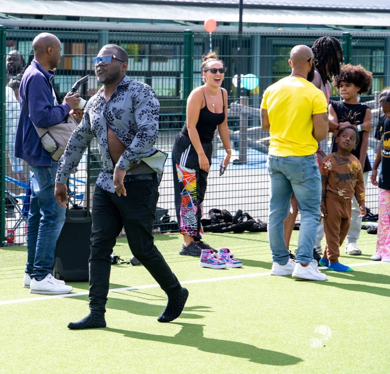 Families gathering on the pitch at Roots & Wings 2024