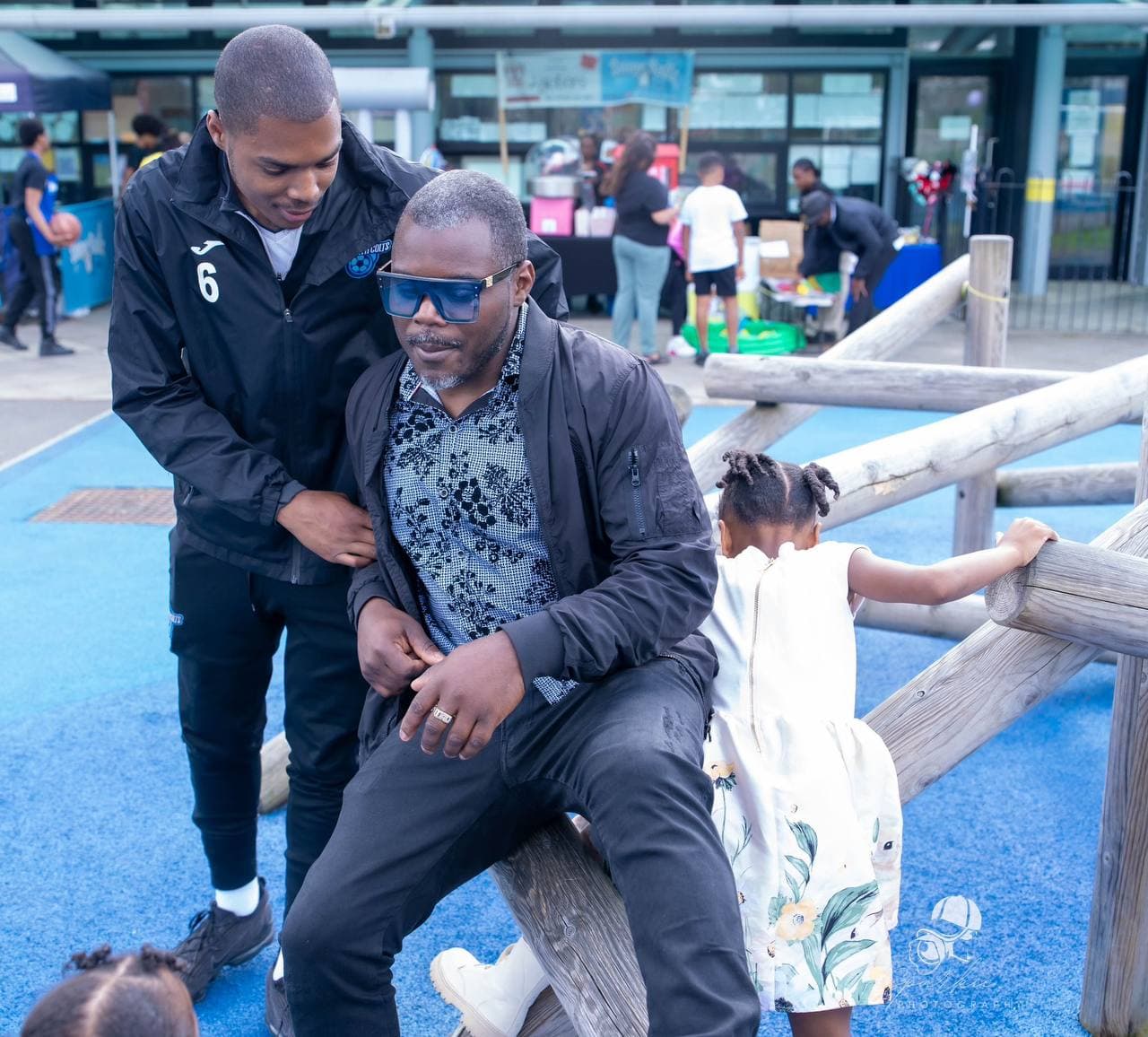 Child and adult spending time together in the playground at Roots & Wings 2024