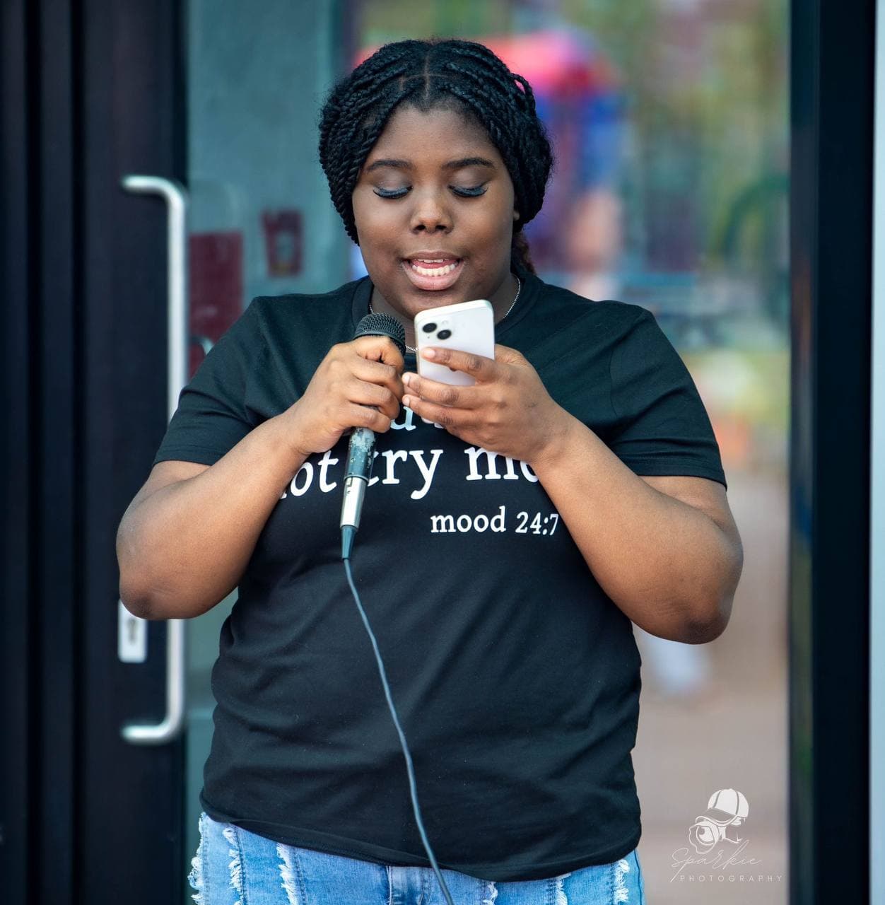Speaker holding a microphone at Roots & Wings 2024