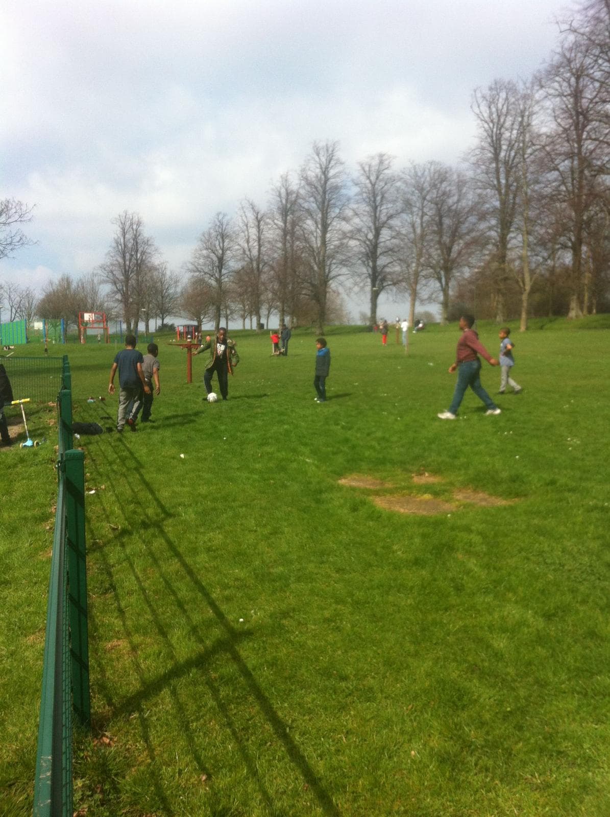 Young people playing football in the park