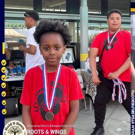 Young person proudly wearing their medal