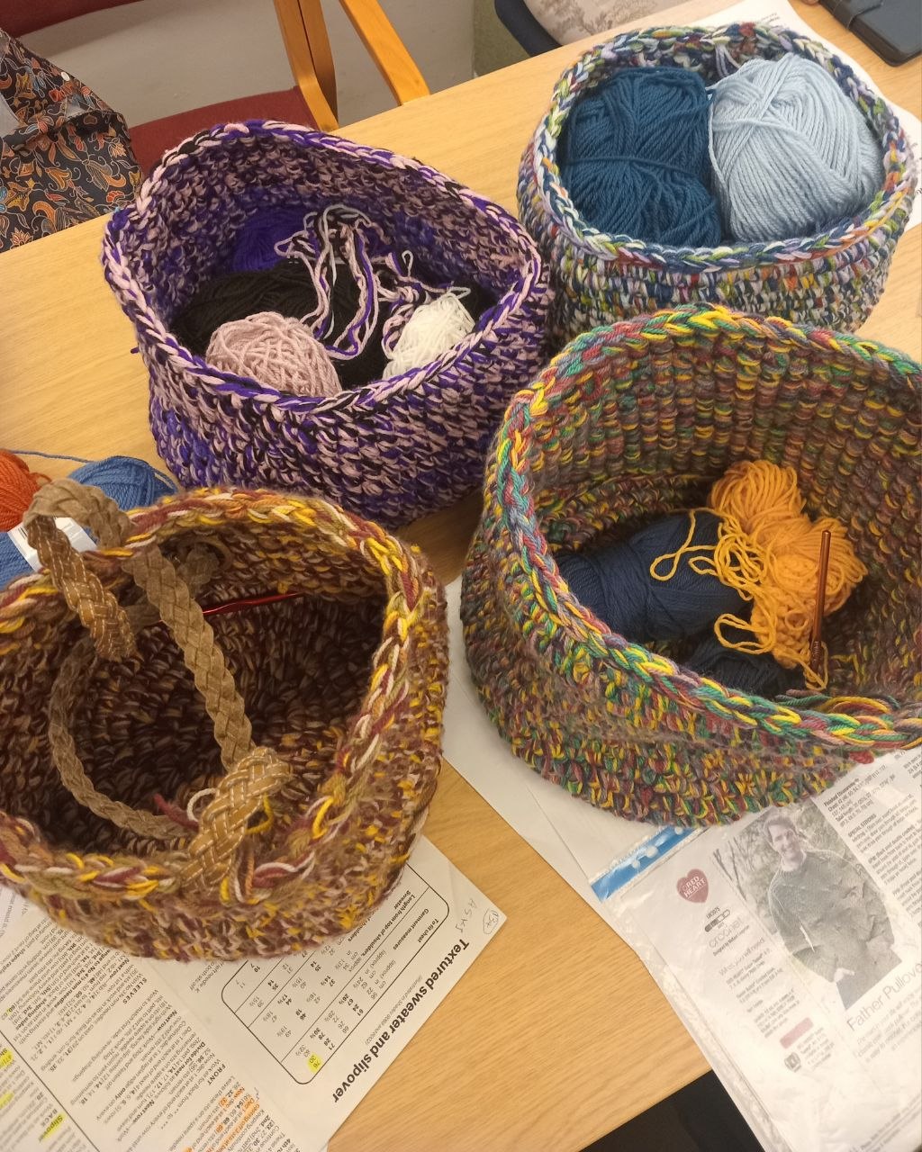 Colourful crochet baskets created with seven strands of DK yarn by Stitch Craft N Knit members