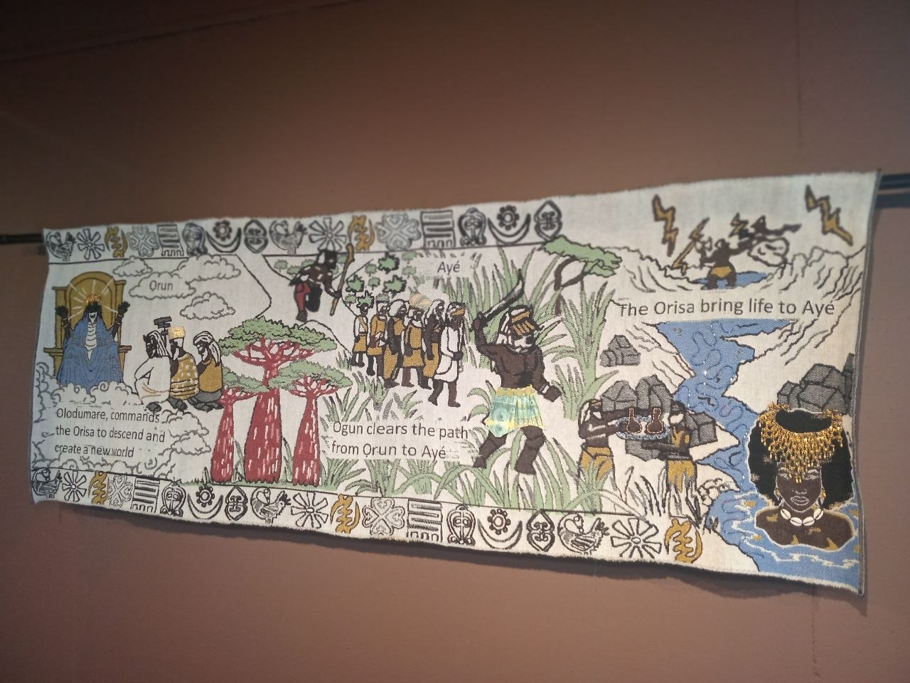 Textile artwork showing cultural storytelling displayed during a Stitch Craft N Knit place of visit