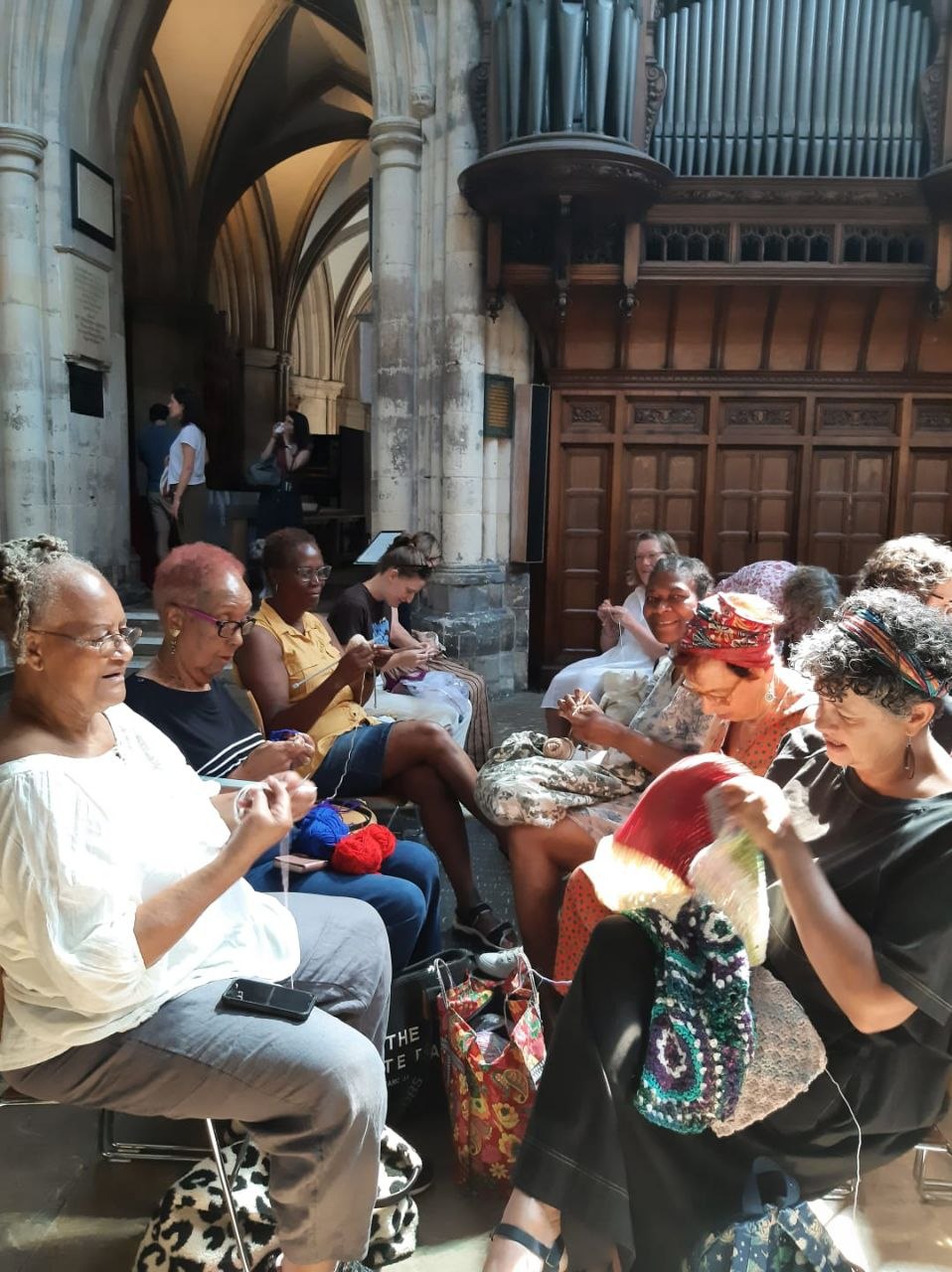 Stitch Craft N Knit members knitting together inside Southwark Cathedral for Big Knit Day